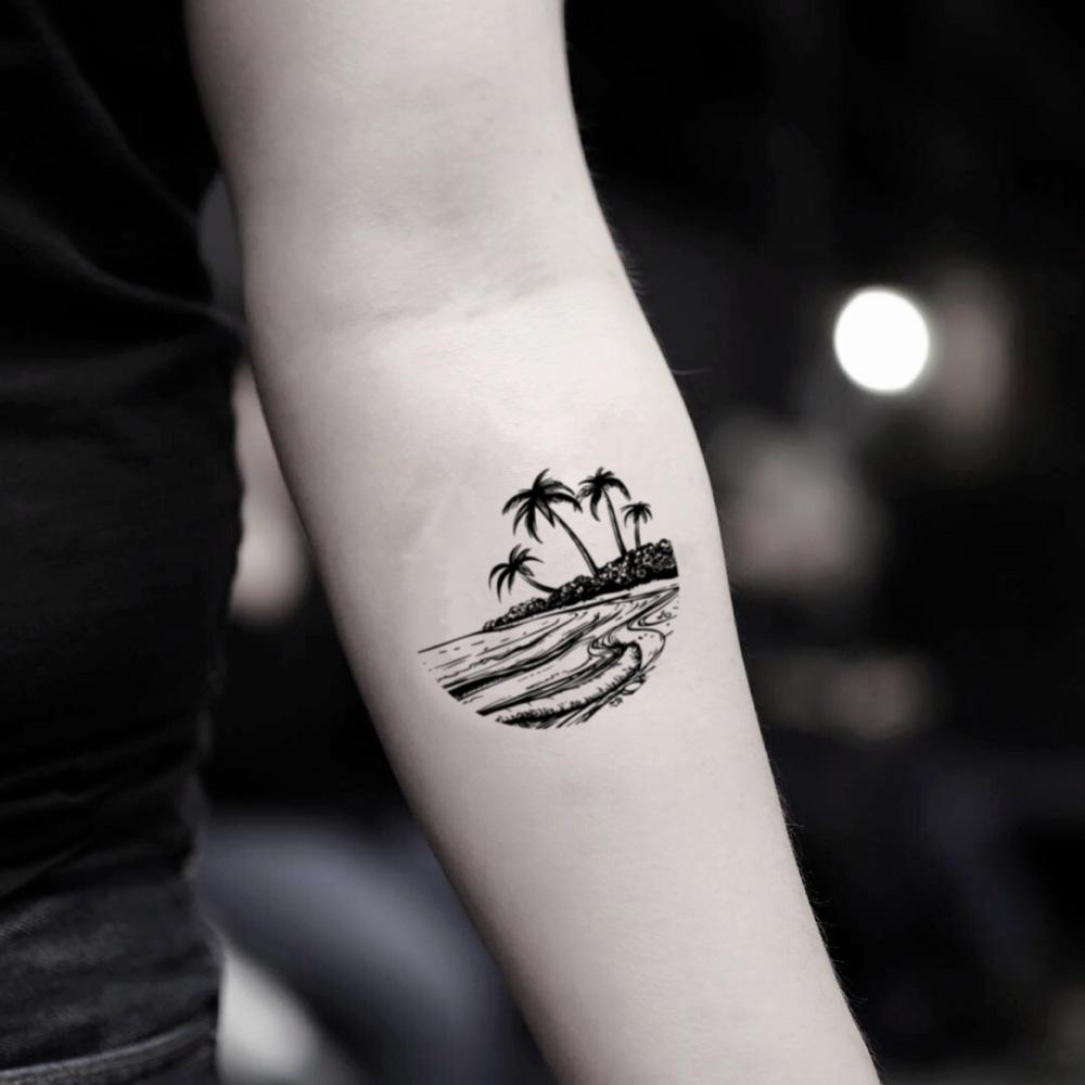 Tiny minimalistic island tattoo located on the wrist.