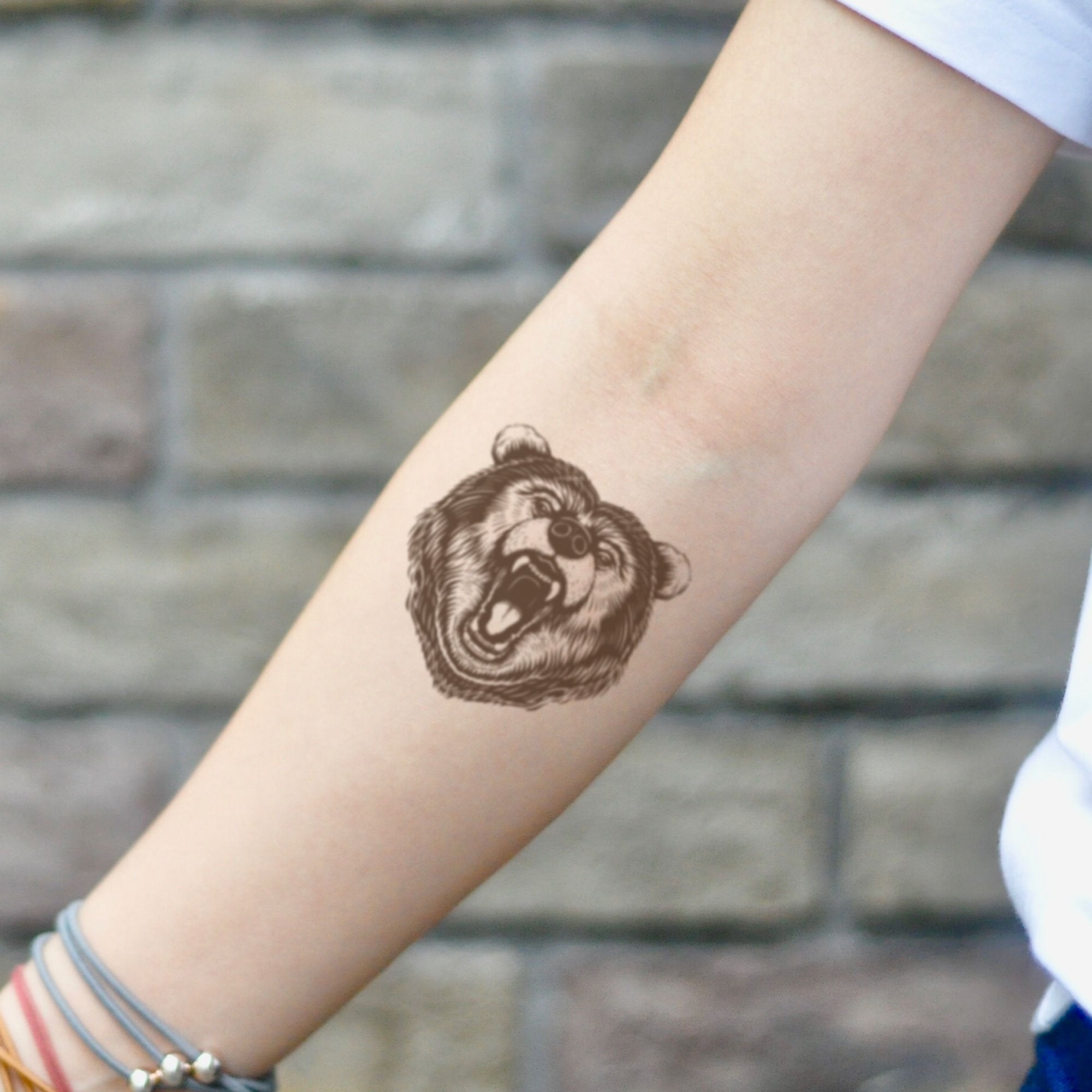 Cute tiny teddy bear tattoo done on the wrist.