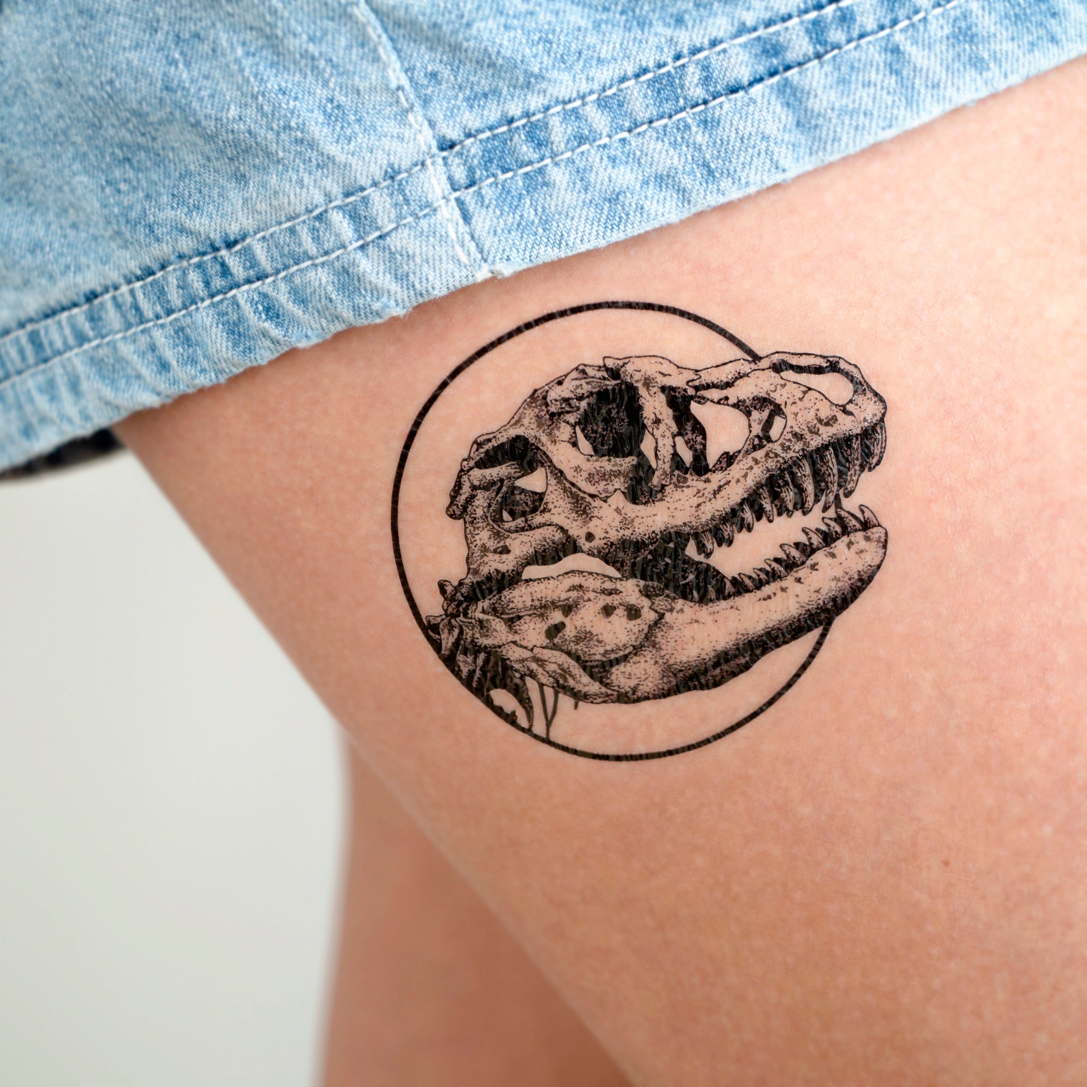 Grey Ink Dinosaur Skull Tattoo On Right Forearm