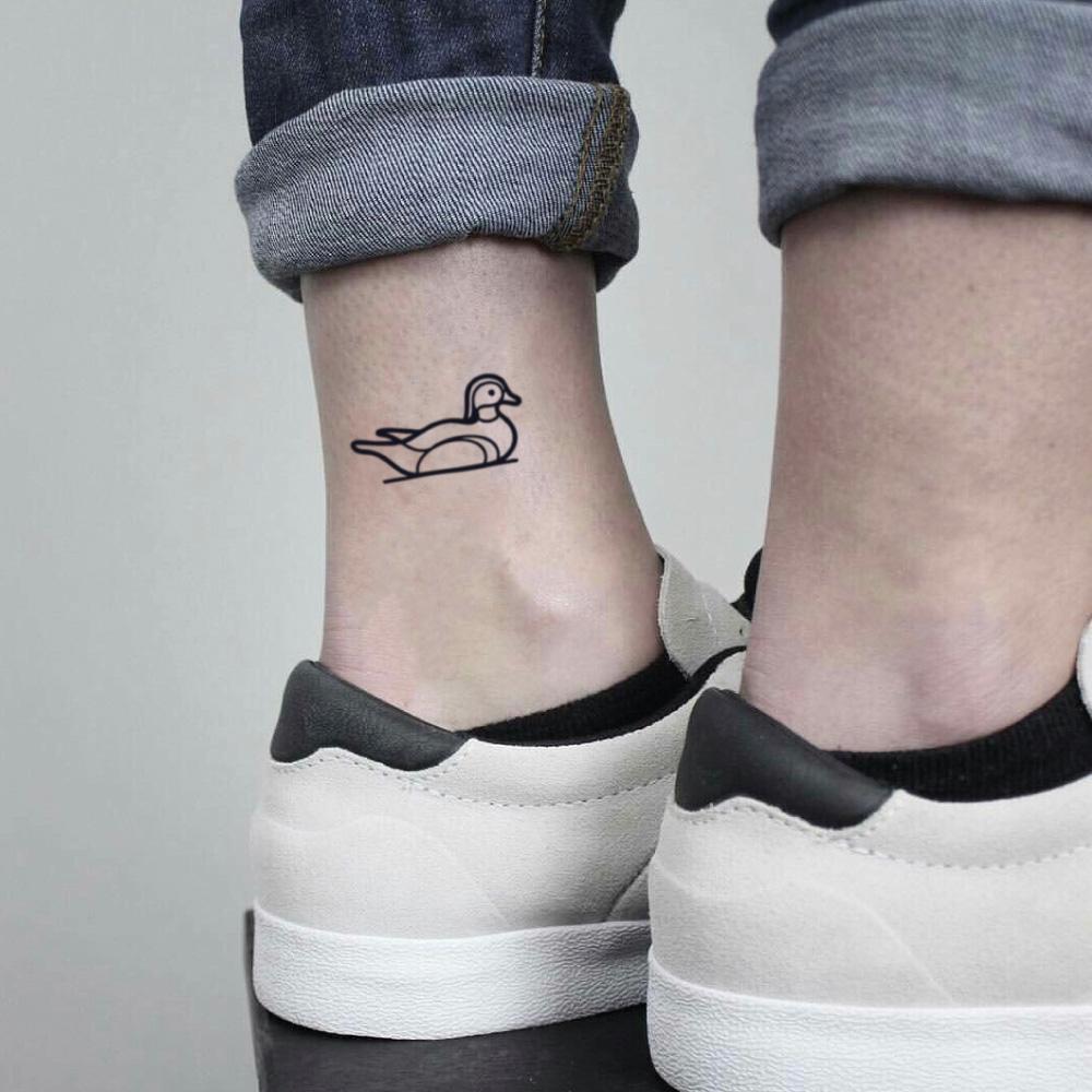 Minimalistic duck tattoo located on the forearm