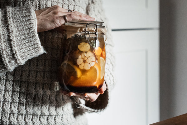 person holding jar of fire cider