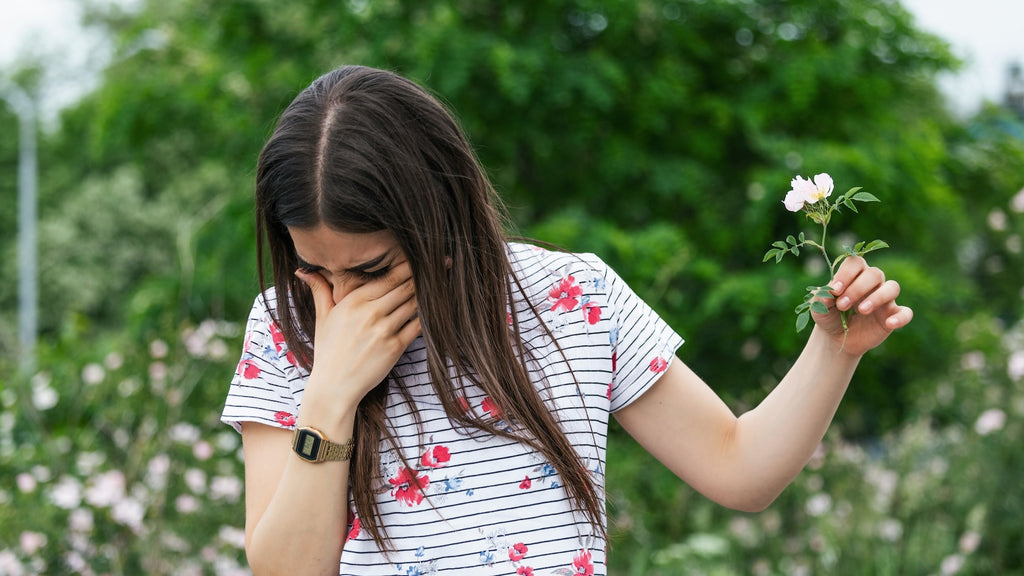 Balmonds - Hayfever Tips with image of a woman holding a flower and sneezing