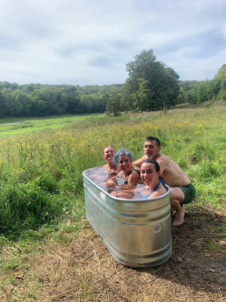 Group in tin cold water bath post sauna