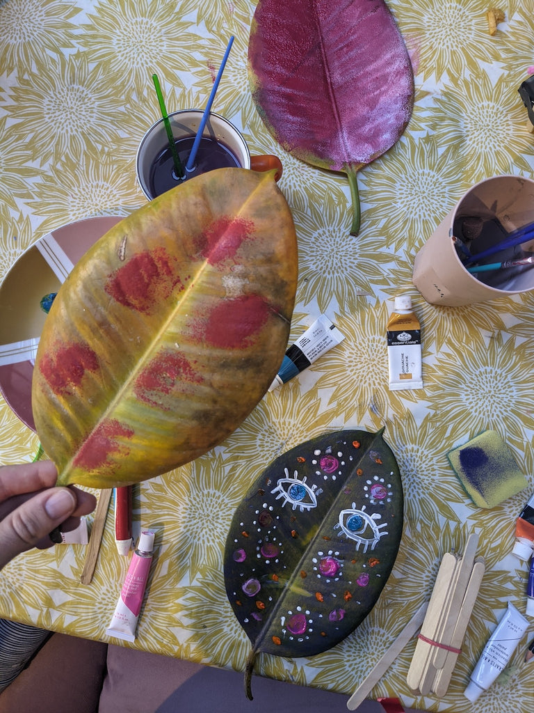 winter indoor craft activities for kids - image shows painted leaves with patterns and faces