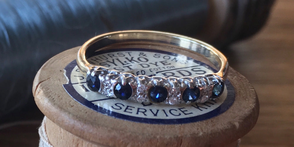 gold ring set with diamonds and sapphires