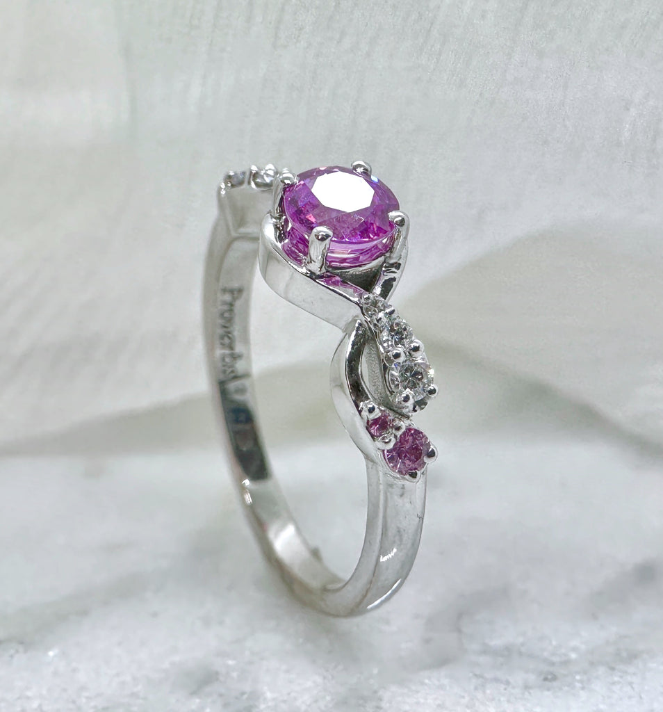 A delicate ring with a paisley-inspired design and set with pink sapphires.