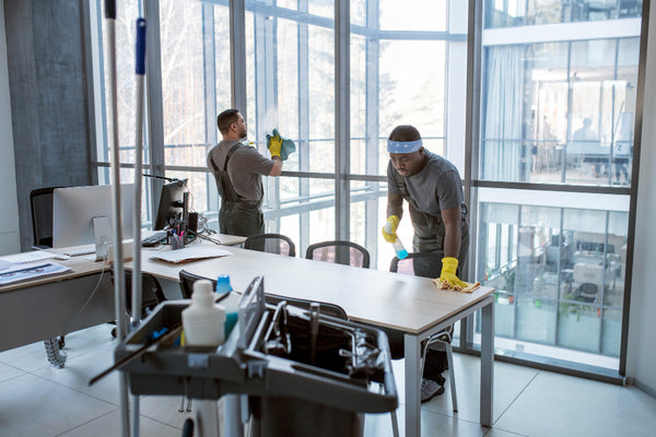Janitorial staff maintaining cleanliness in an office environment