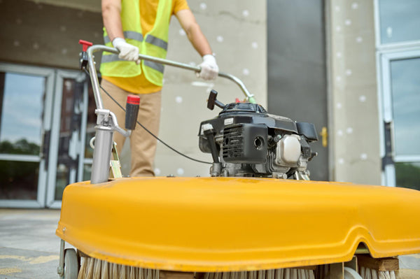 Closeup view of an industrial floor scrubber in action