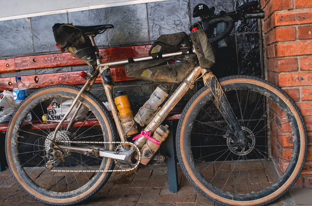 Abdullah's bike at a road side supermarket, with Apidura bags