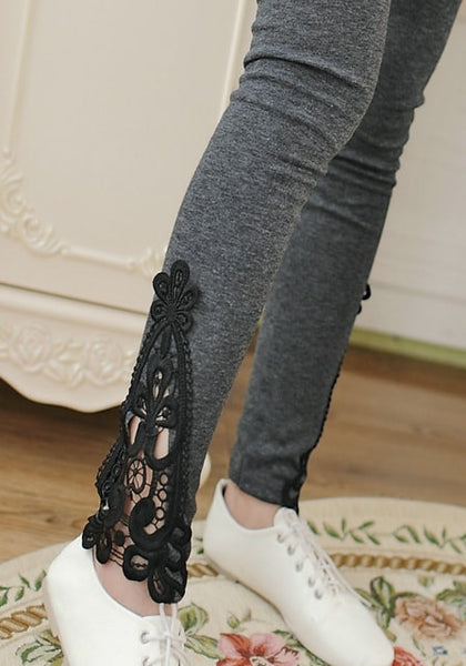 Close-up of model's ankle with grey lace-trim leggings