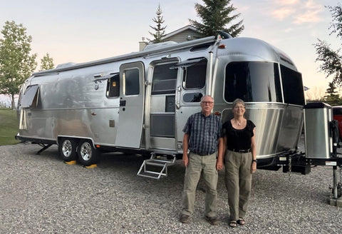 Karen Richardson and her husband with their Airstream