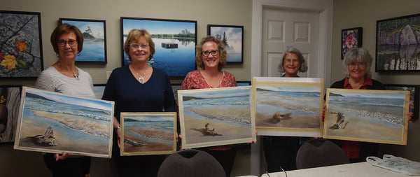 Students with driftwood beach paintings, workshop taught by Karen Richardson