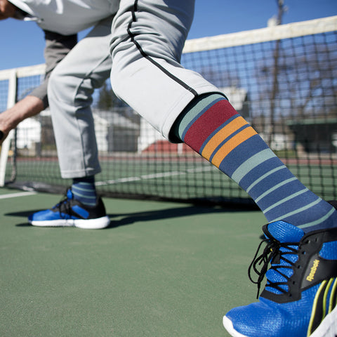 playing football wearing his 30-40 mmHg: Rise Stripe Slate Blue & Maroon (Nylon) Compression Socks