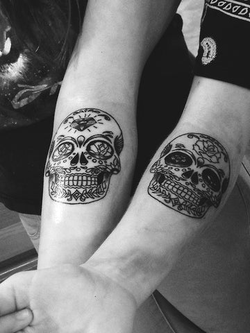 Couple tattoos skulls 