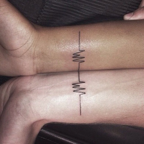 Couple tattoos heart beat