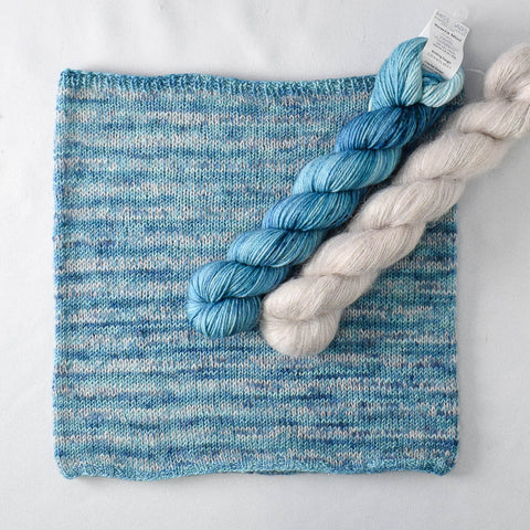 Striped blue and cream cowl with yarn