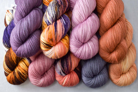 Purple and orange skeins of Yowza yarn
