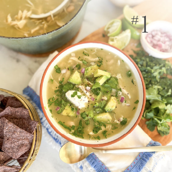 Tortilla soup served with lime and tortilla chips