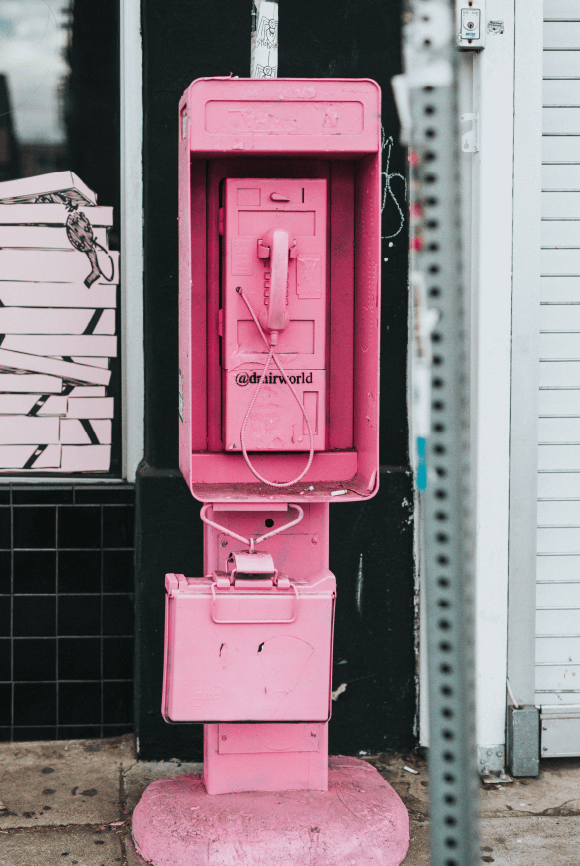 Pink phone booth on street