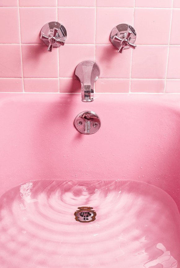 Pink tiled bathtub with rippling water