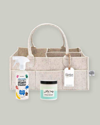 Beige felt diaper caddy, with a bottle of stain remover, and baby ointment