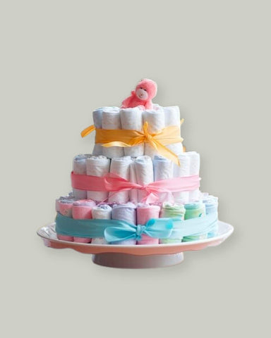 3 tier cake made of diapers, tied with colorful ribbon
