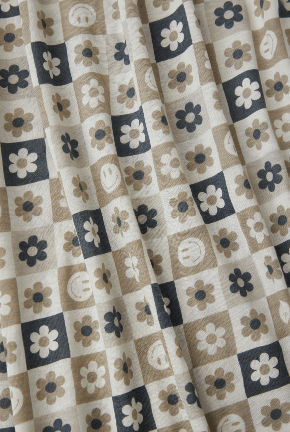 Checker fabric with neutral tones and smiley faces and flowers