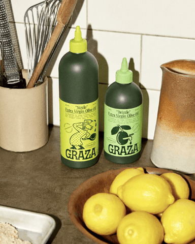 Set of 2 Graza olive oil containers on kitchen counter