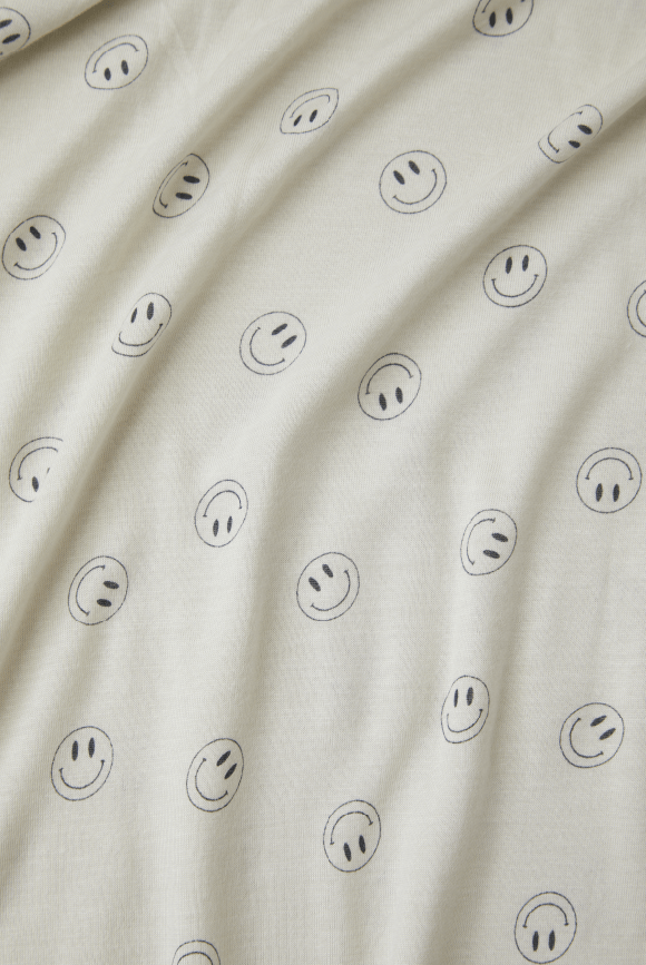 Cream fabric with smiley faces