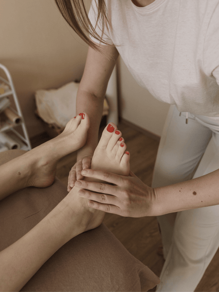 Woman with red toe nails gets massage