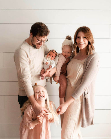 Family with mom, dad, and 3 kids smiles