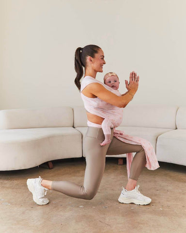Woman working out while babywearing in the Bloom Solly Wrap