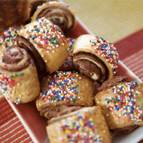 Rolled pastry with chocolate and rainbow sprinkles