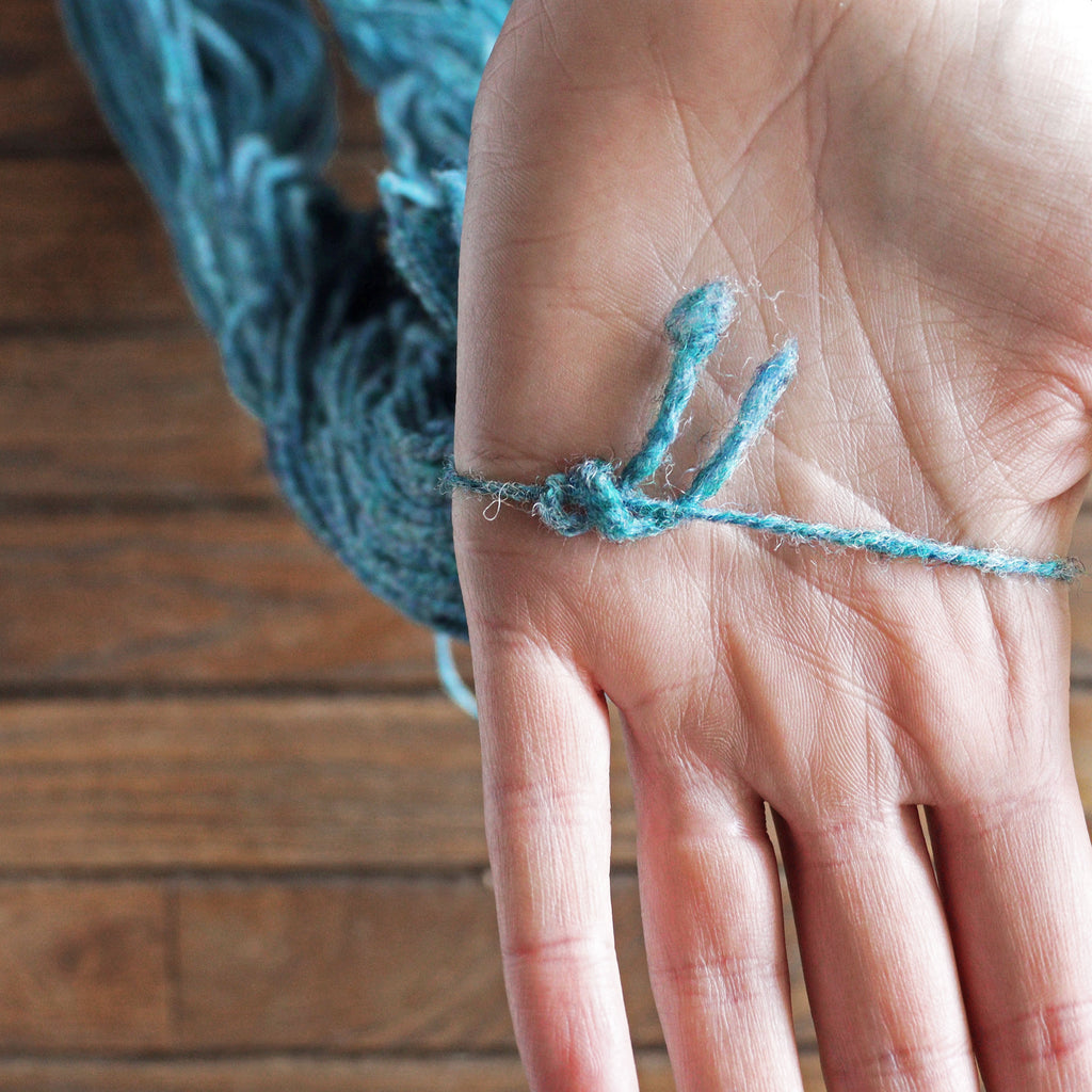 Tie on skein of yarn, shown on hand