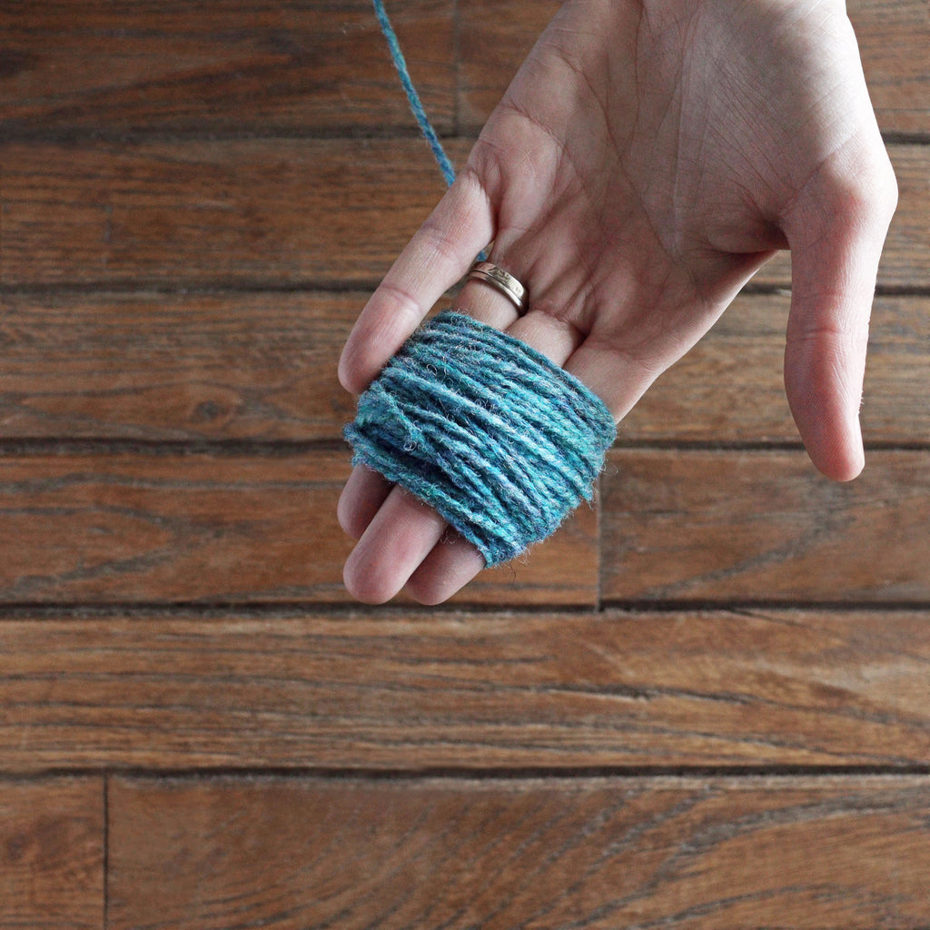 beginning of yarn skein being wound into a ball