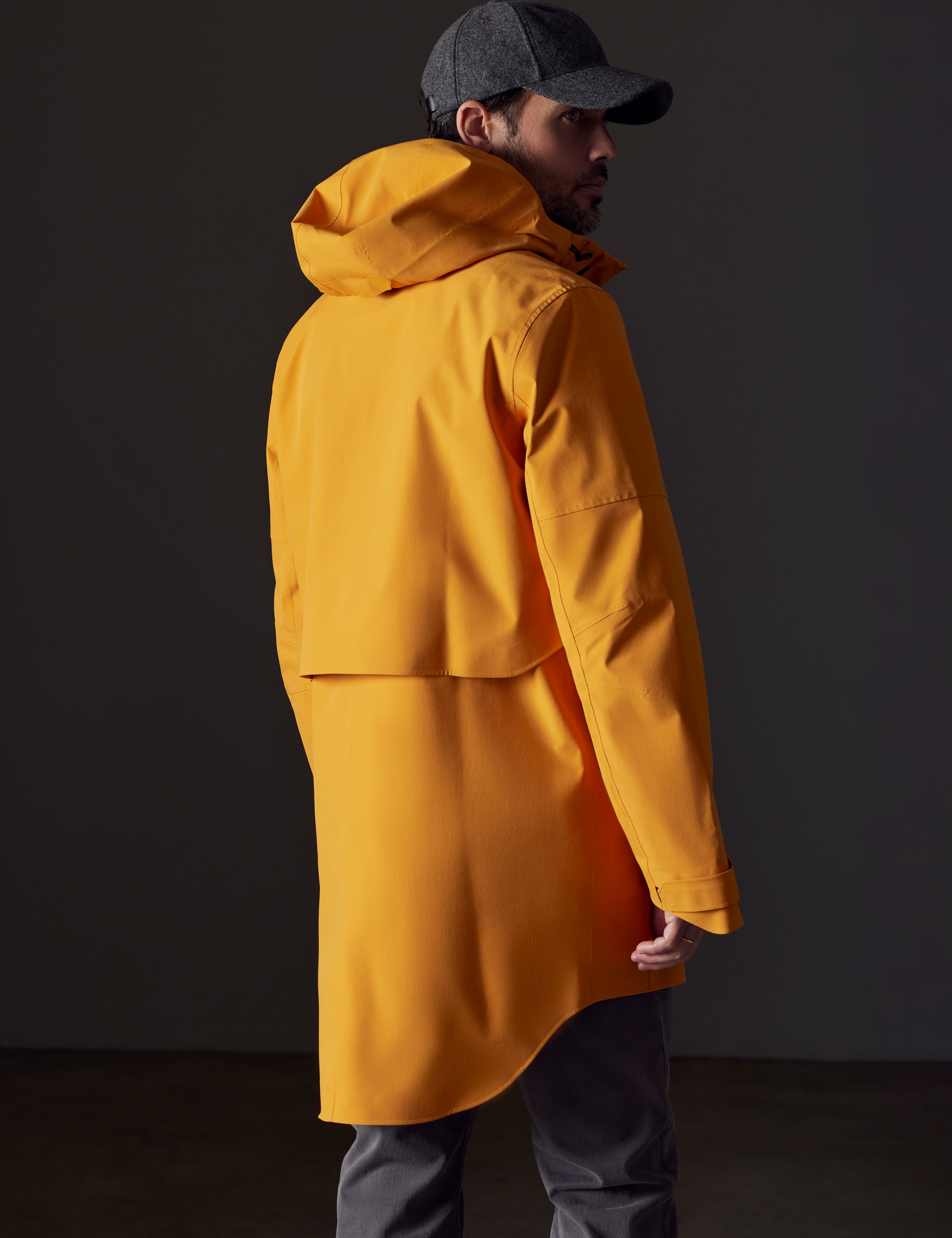 Man wearing orange rain jacket from AETHER Apparel