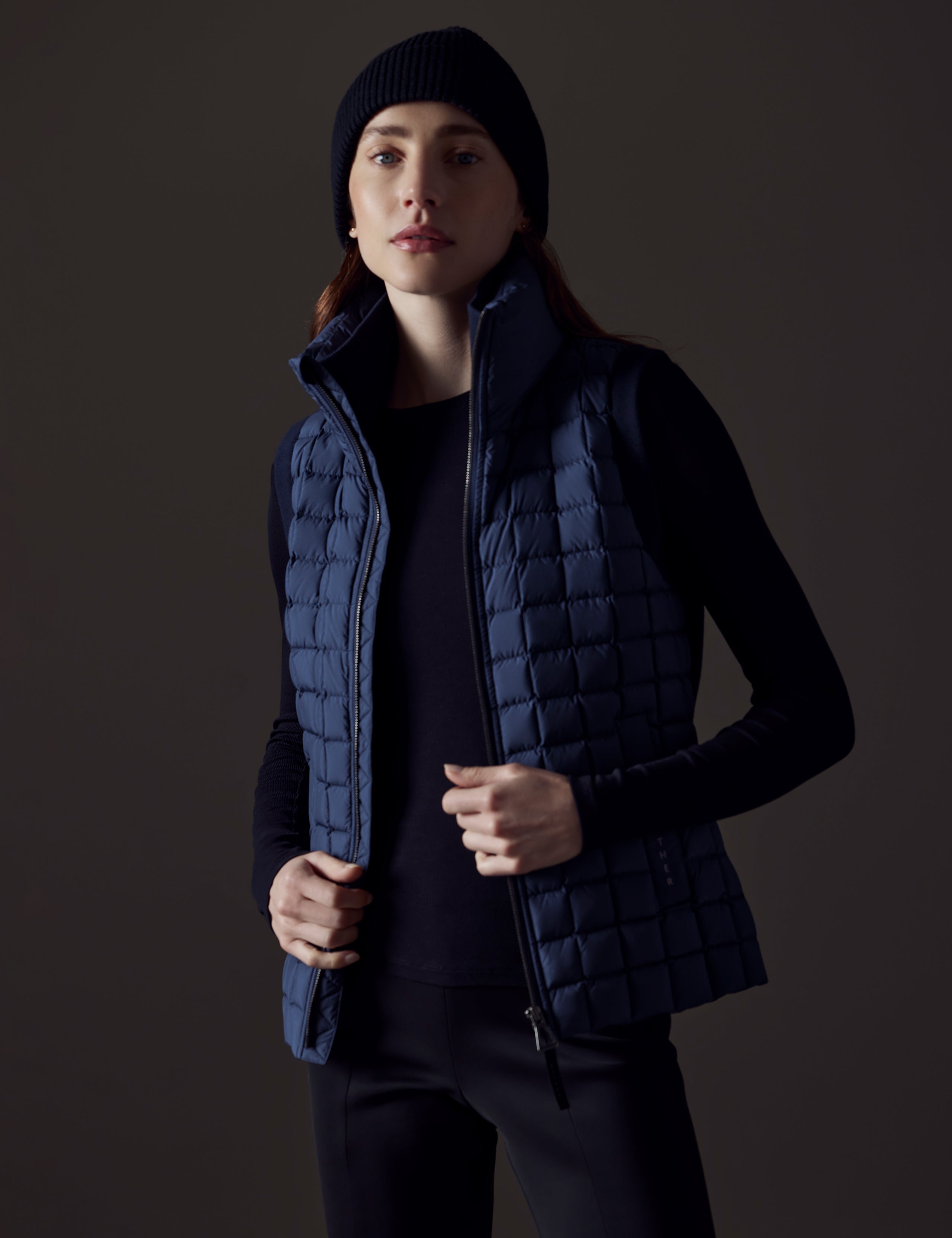 woman wearing blue insulated vest from AETHER Apparel