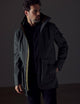 Man wearing dark green parka from AETHER Apparel