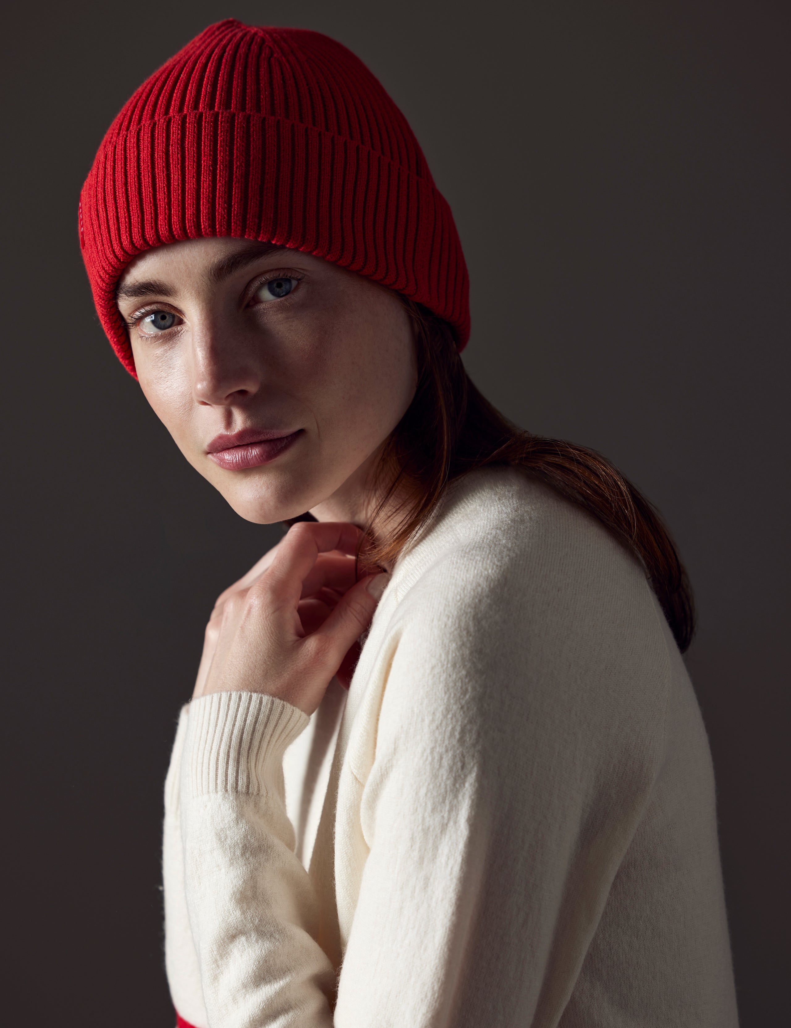 woman wearing red cotton beanie from AETHER Apparel