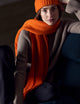 woman wearing orange cashmere scarf from AETHER Apparel