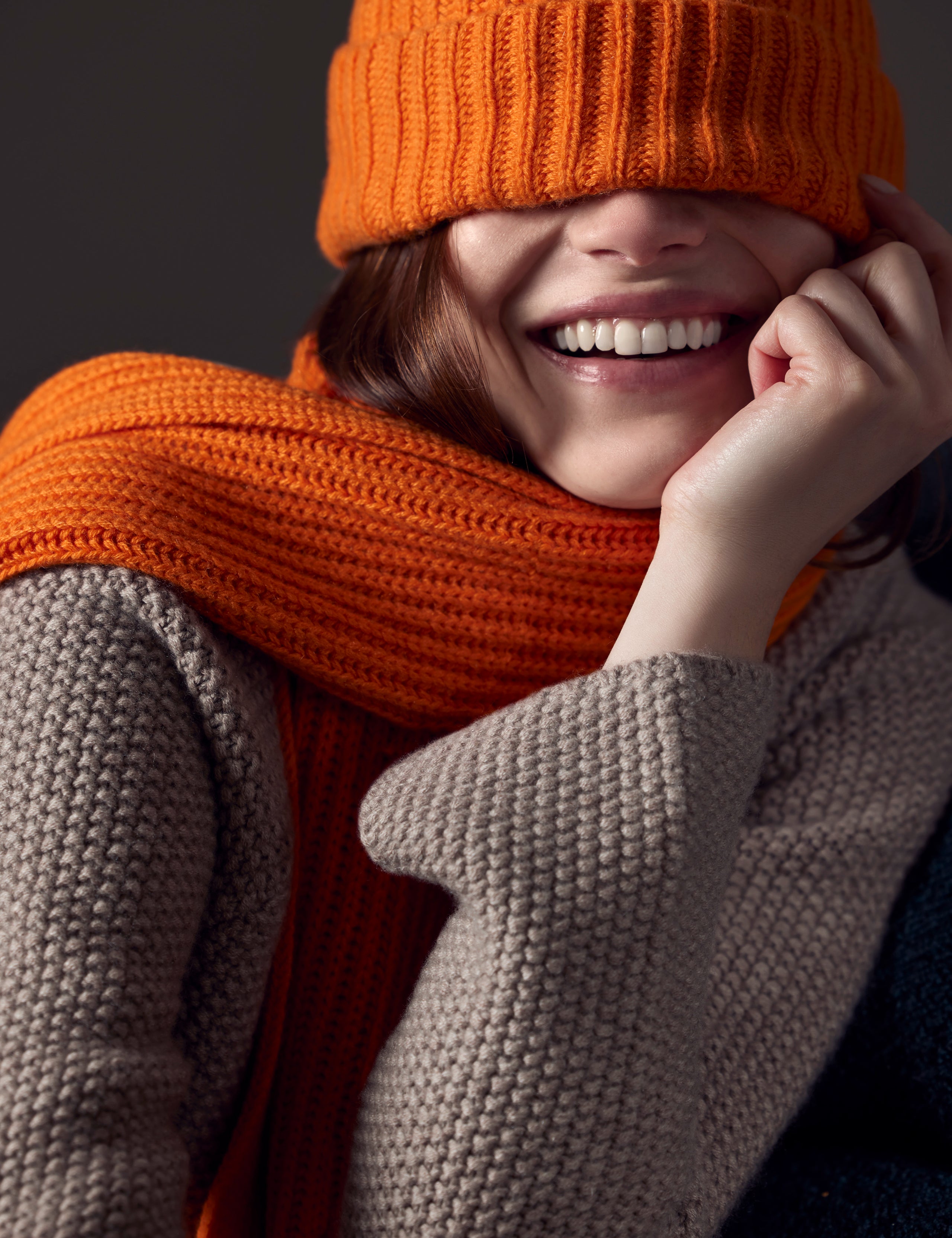 woman wearing orange cashmere scarf from AETHER Apparel