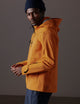 man wearing orange snow shell from AETHER Apparel