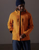 man wearing orange snow shell from AETHER Apparel