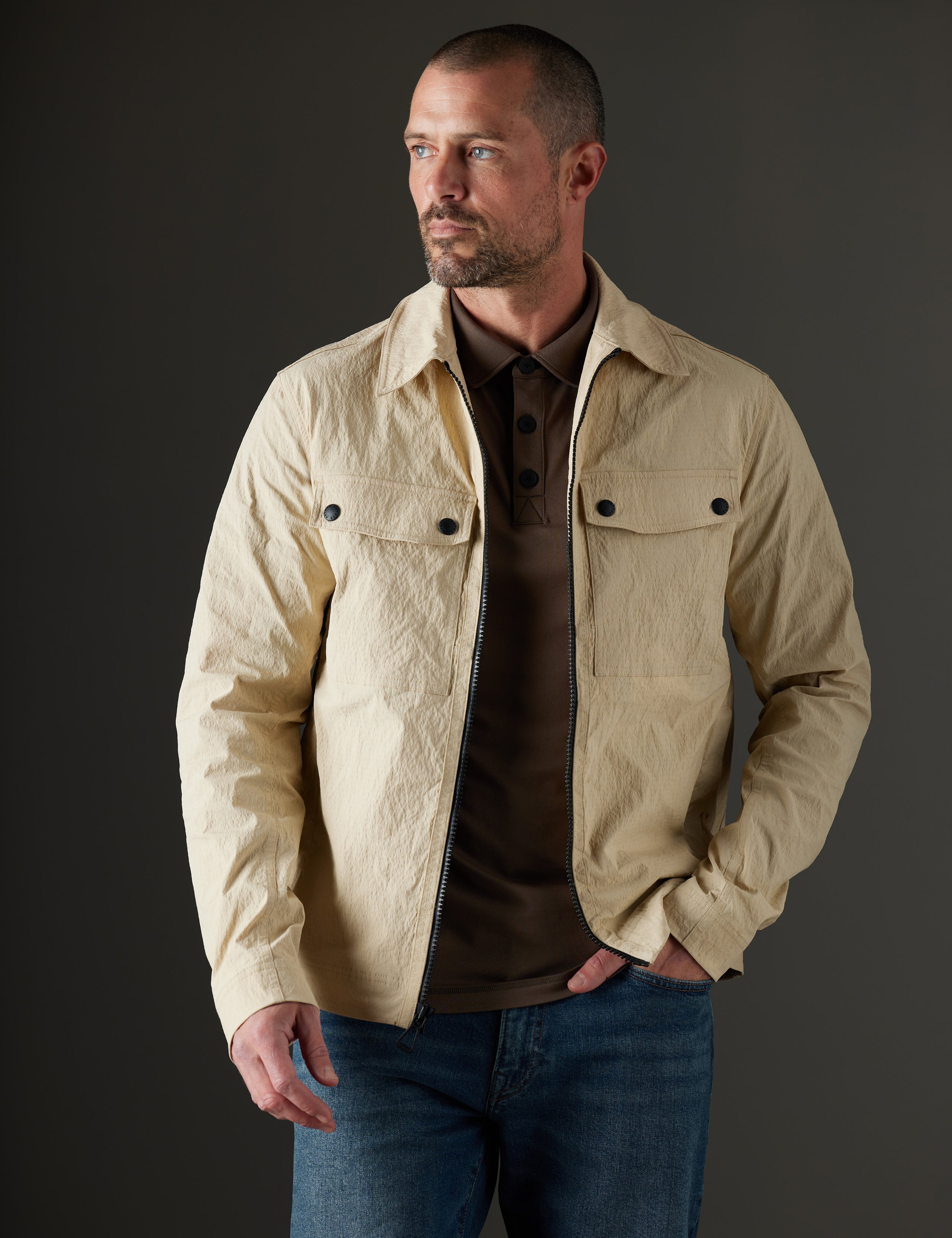 Man wearing beige jacket from AETHER Apparel