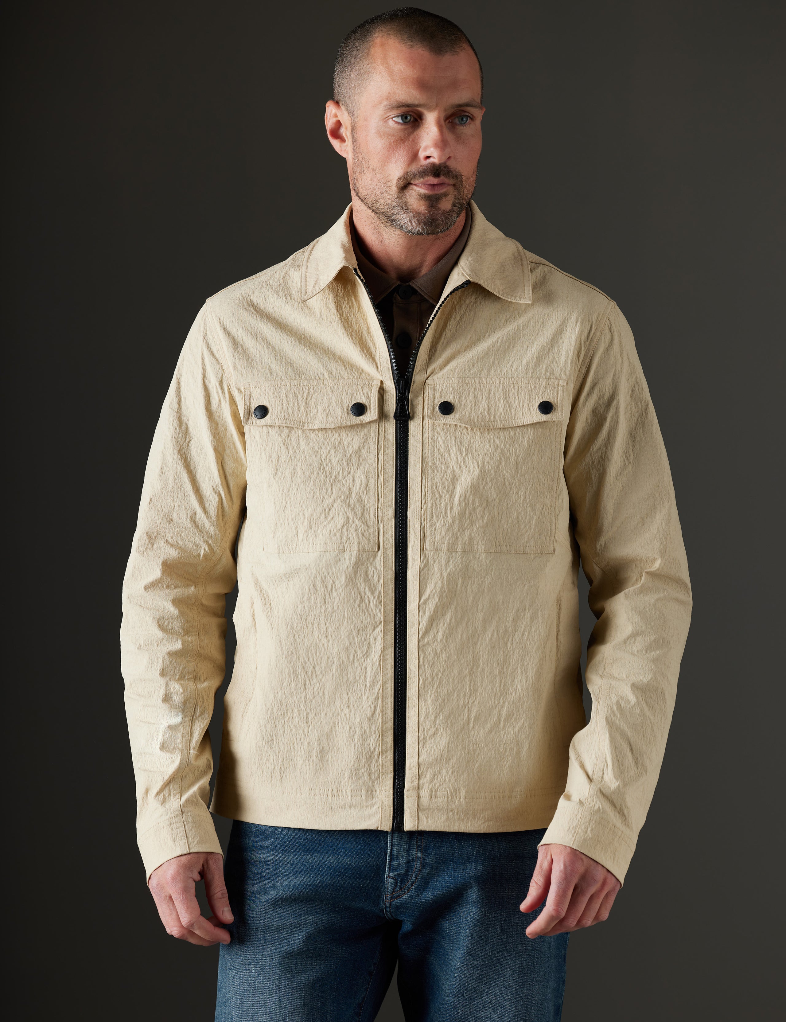 Man wearing beige jacket from AETHER Apparel