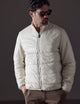 Man wearing white Eco Insulated Jacket from AETHER Apparel