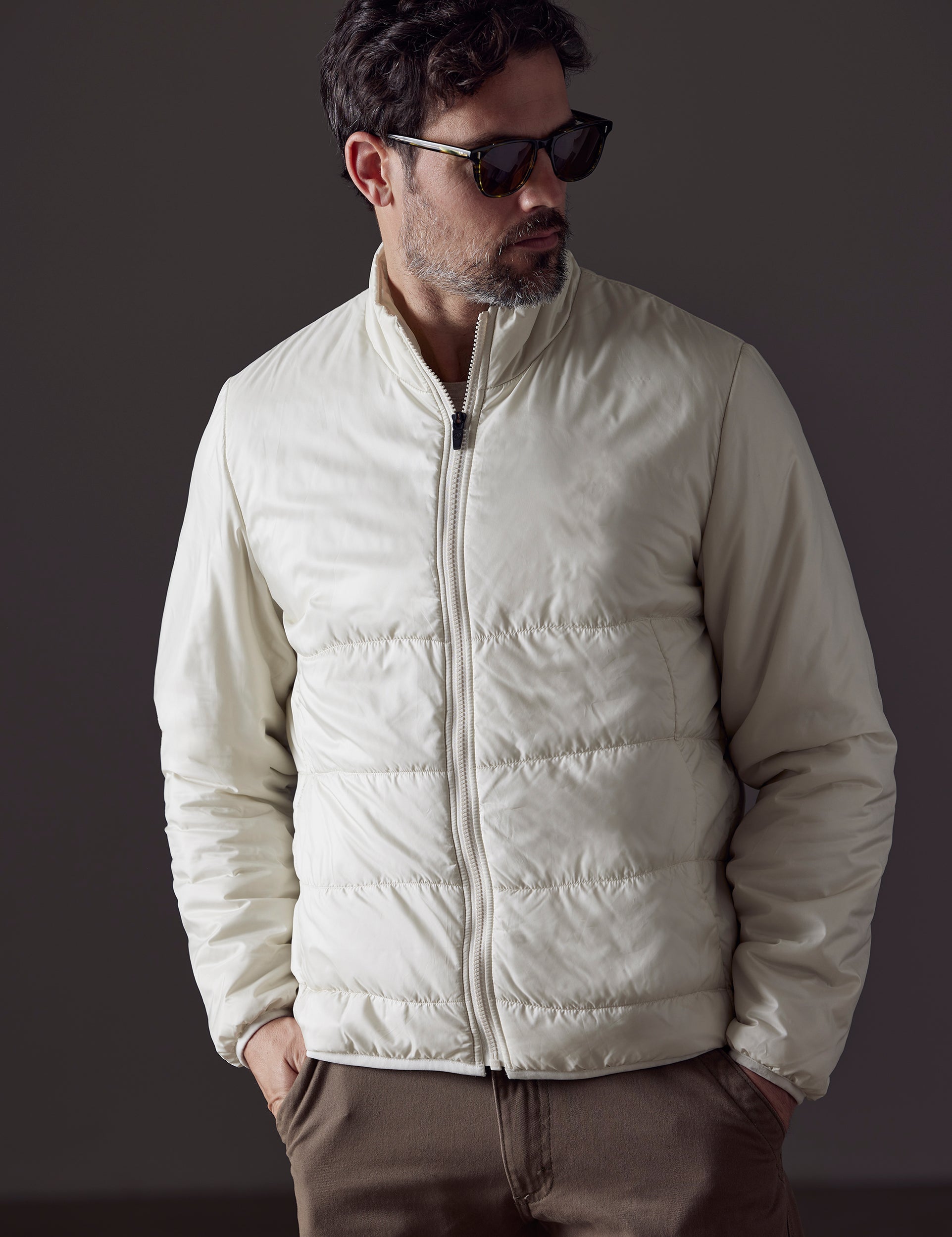 Man wearing white Eco Insulated Jacket from AETHER Apparel