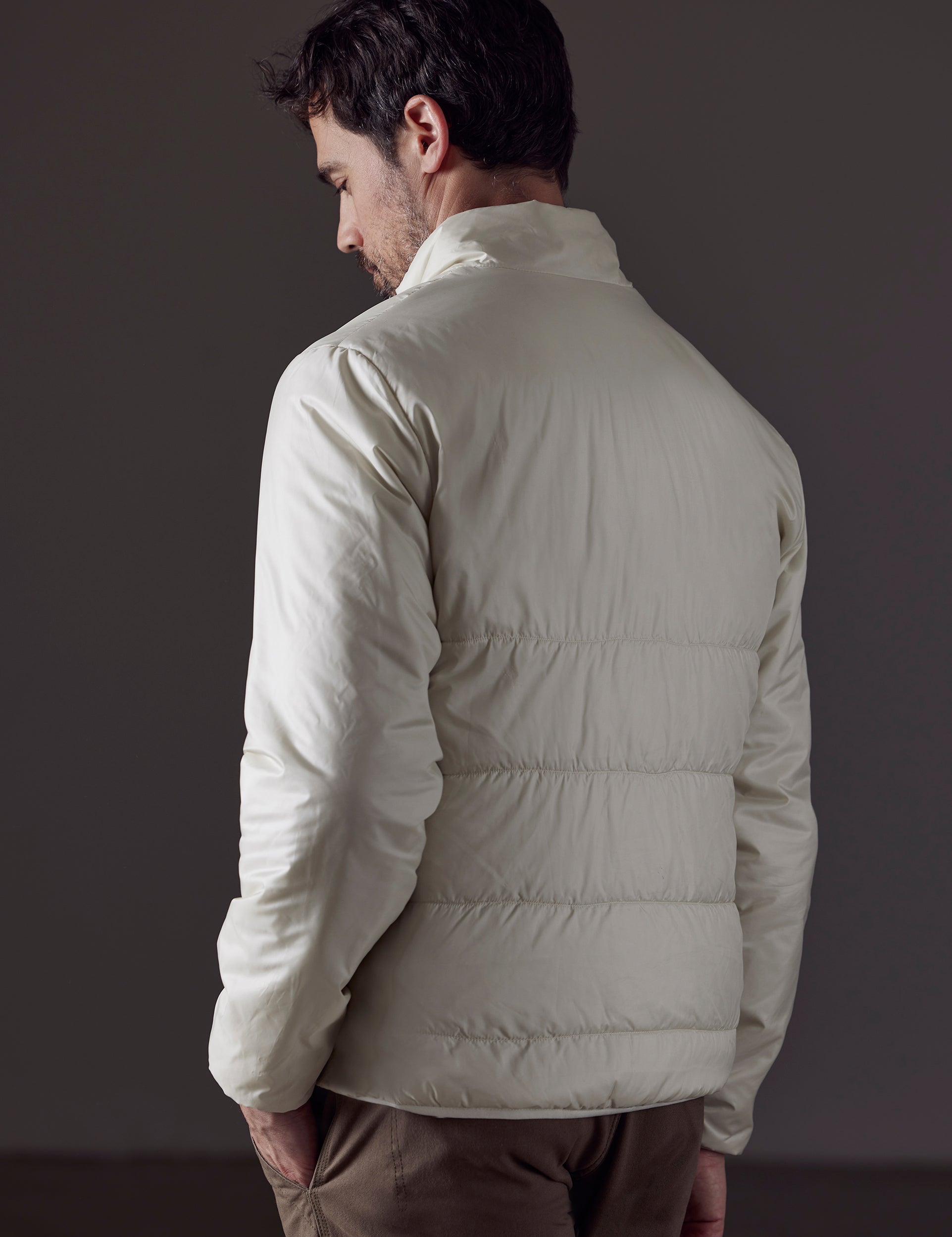 Man wearing white Eco Insulated Jacket from AETHER Apparel