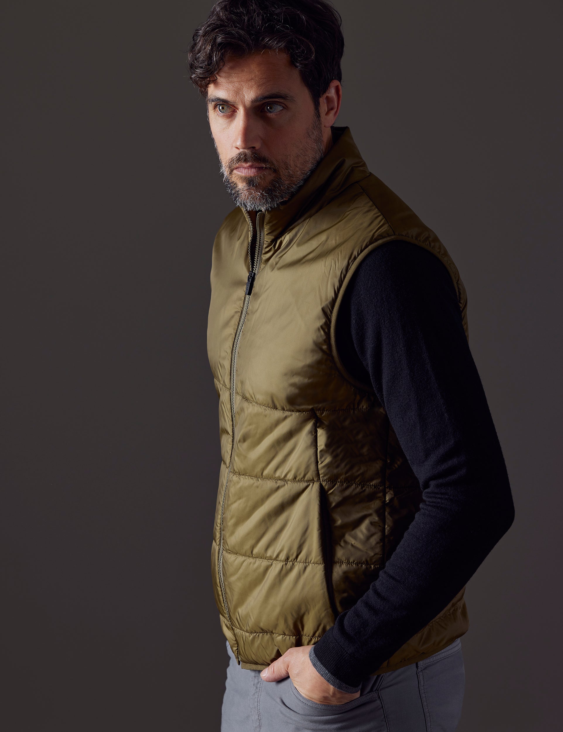 Man wearing green Eco Insulated Vest from AETHER Apparel
