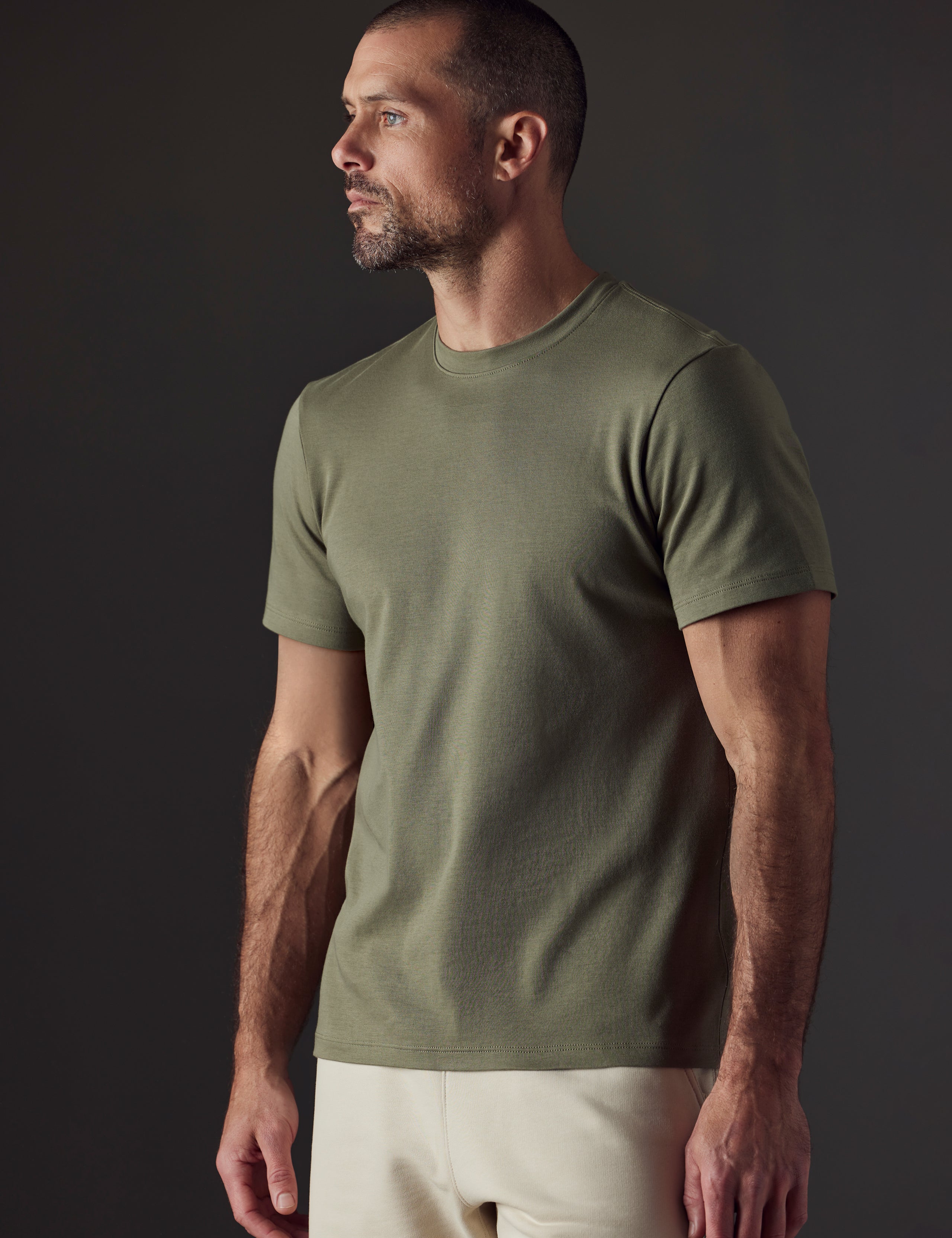 Man wearing green organic cotton tee from AETHER Apparel